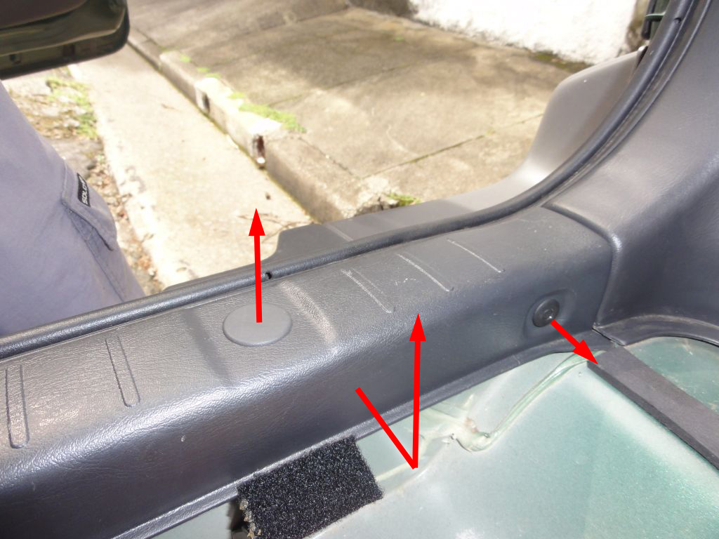 Remove the back trim. Release the clips as indicated in the next picture and pull this part out. Don't use any tools, be gentle. Before removing it completely, take a look in the way the rubber finish covers this part. You'll need to remember that when assembling it back.