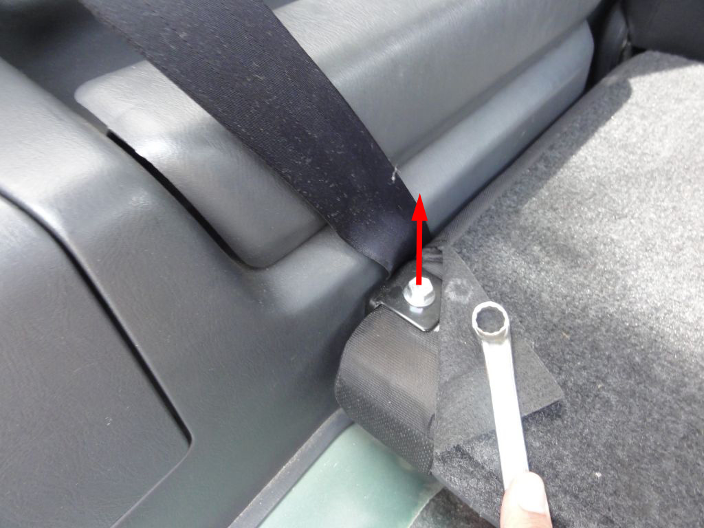 Fold down the back of the seats. On the bottom corner, under the mat, you'll find another screw. Before removing this screw, take a careful look at the pivot and pay attention in the way it holds the seat and the cover fabric. After removing these screws you'll be able to take the seats off.